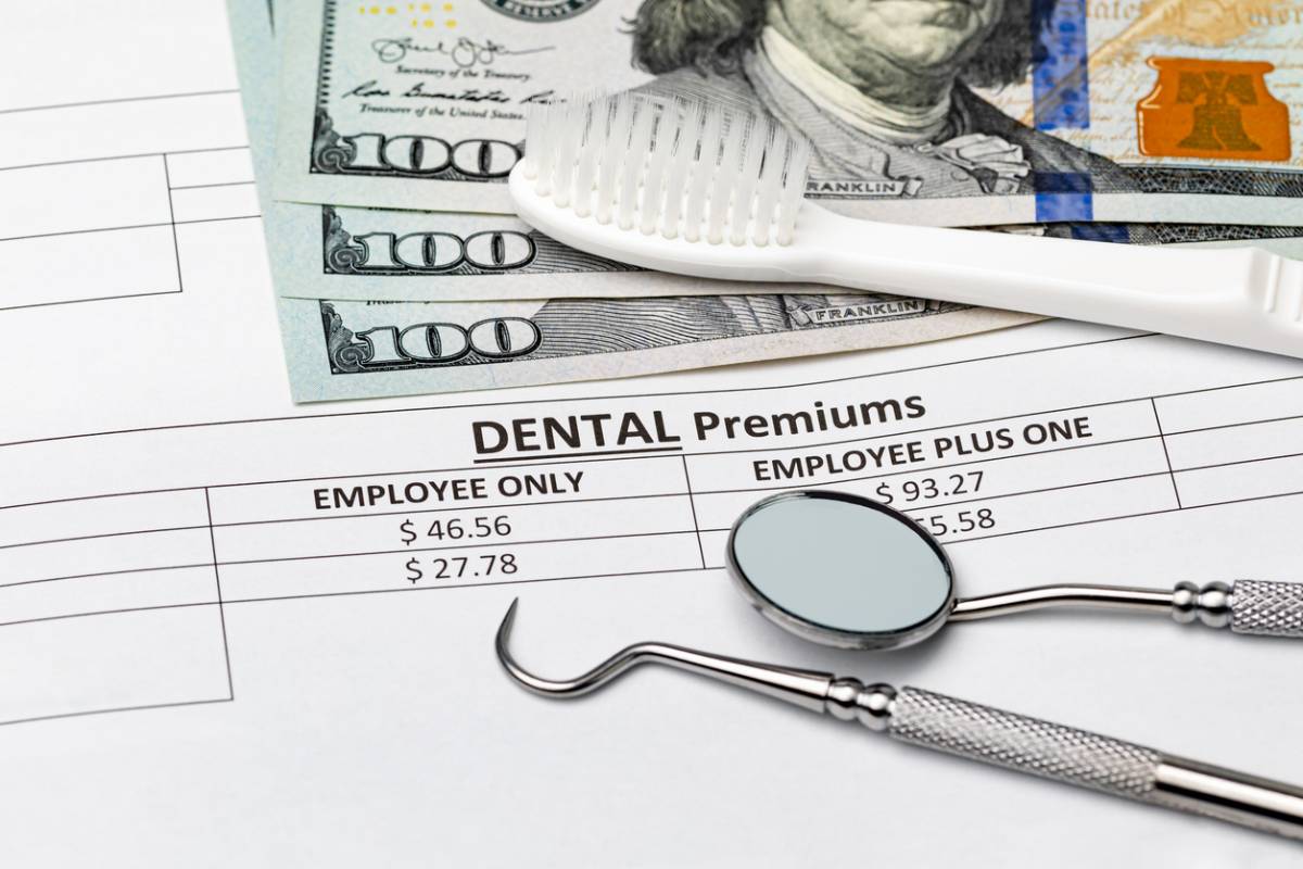 Insurance papers with dental tools.