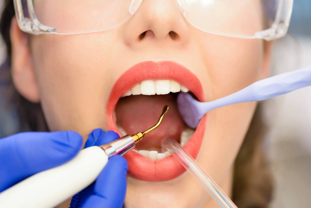 Young female patient undergoing root canal therapy during dental procedure.
